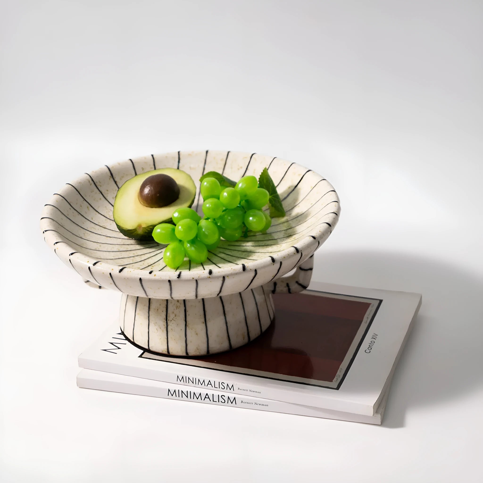 Black and white striped synthetic resin fruit dessert plate on a table