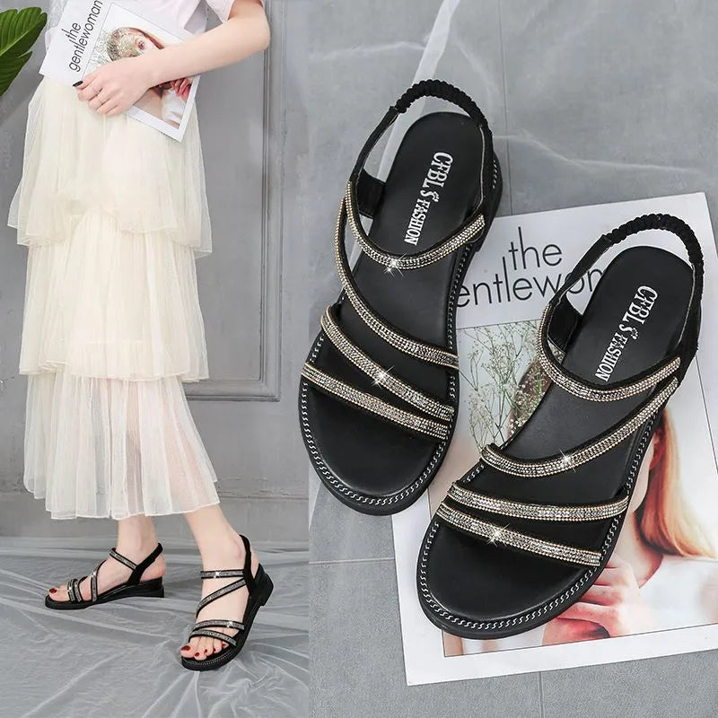 Women's gold Korean-style flat sandals with rhinestone detail and elastic band on a rubber sole.