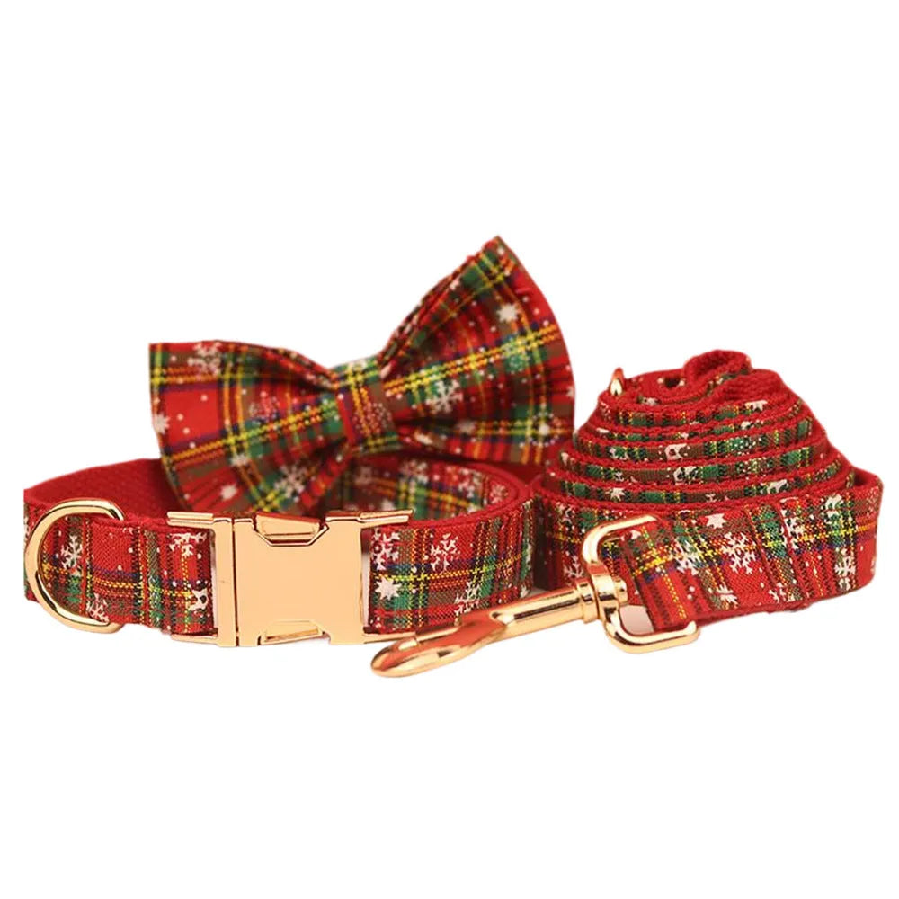 Red snowflake plaid dog collar and leash set with matching vest and decorative bow.