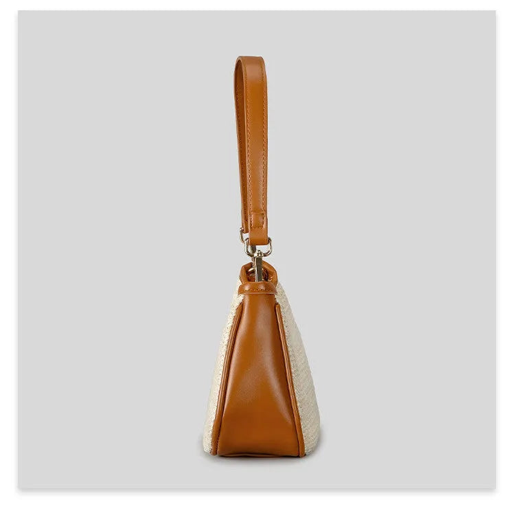 Khaki coloured hand-woven straw crossbody bag with a single strap and an internal phone pocket.