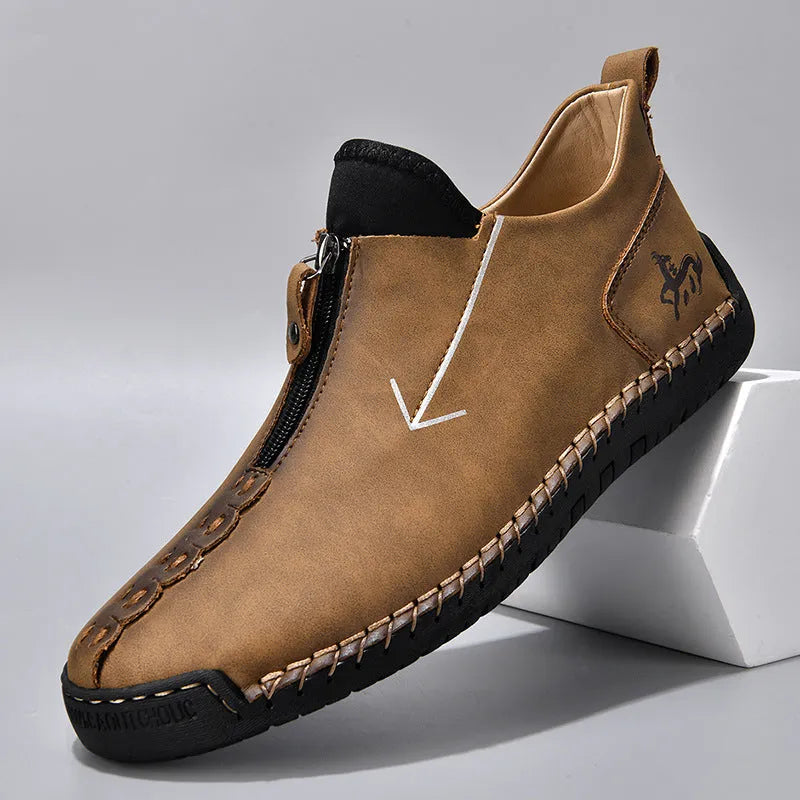 Men's black leather ankle boots with front zipper and round toe on rubber sole