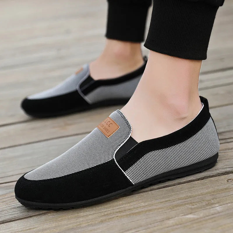 Men's grey and khaki canvas slip-on board shoes with round toe and rubber sole.