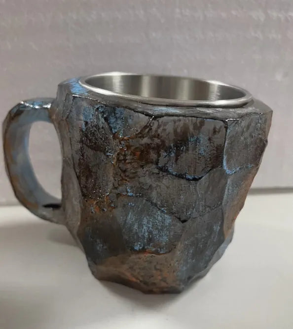 Purple resin coffee mug with handle showing crystal-like transparency on a table.