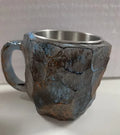 Purple resin coffee mug with handle showing crystal-like transparency on a table.