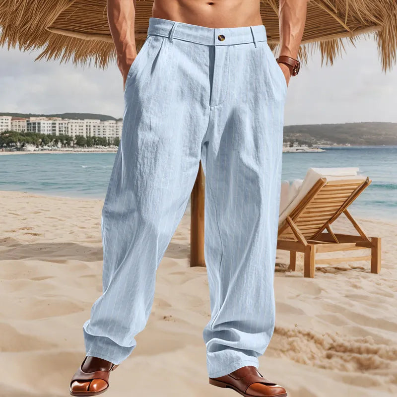 Man wearing beige striped linen trousers with a high waist and wide loose legs.