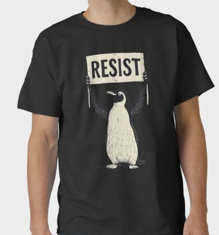 A loose-fitting black cotton T-shirt with short sleeves and a round neck on a hanger.