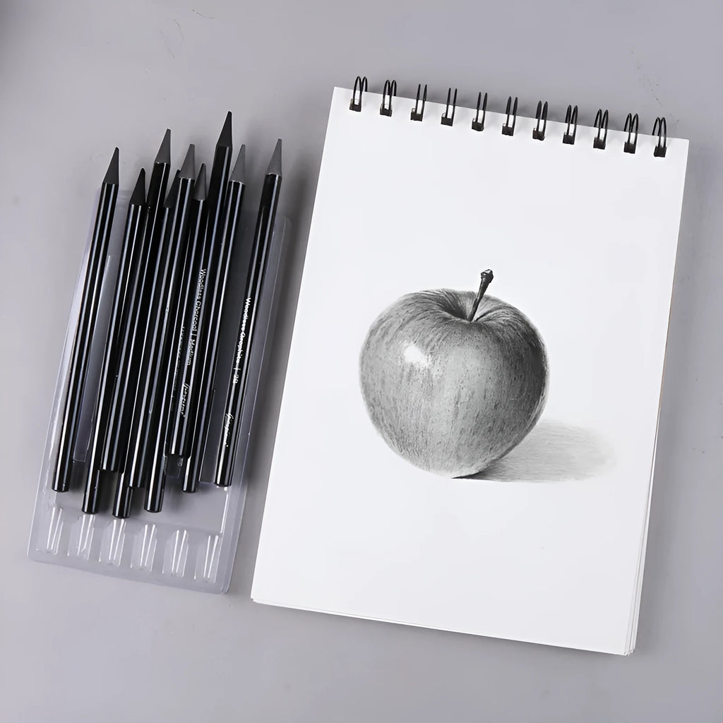 Set of six graphite and three carbonised drawing pencils on suction card packaging