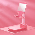 Folding telescopic mobile phone bracket in blue on a desktop, holding a smartphone securely with its silicone pad.