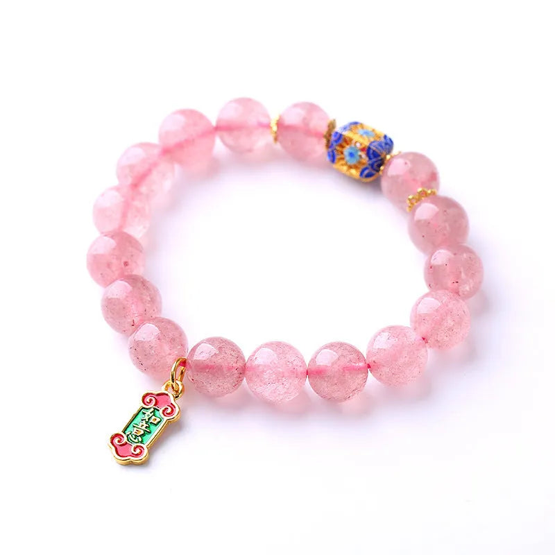 Close-up of hand-woven pink strawberry quartz crystal bracelet with Ruyi motif design