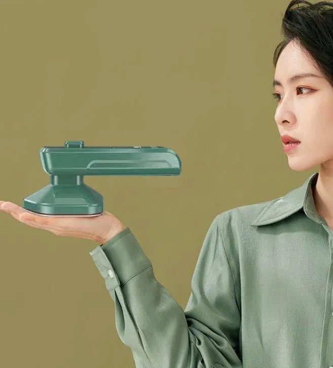 Dark green portable hand-held steam ironing machine with a ceramic panel.