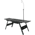 Black foldable steel outdoor barbecue table with integrated grill set, shown in round and square design options.