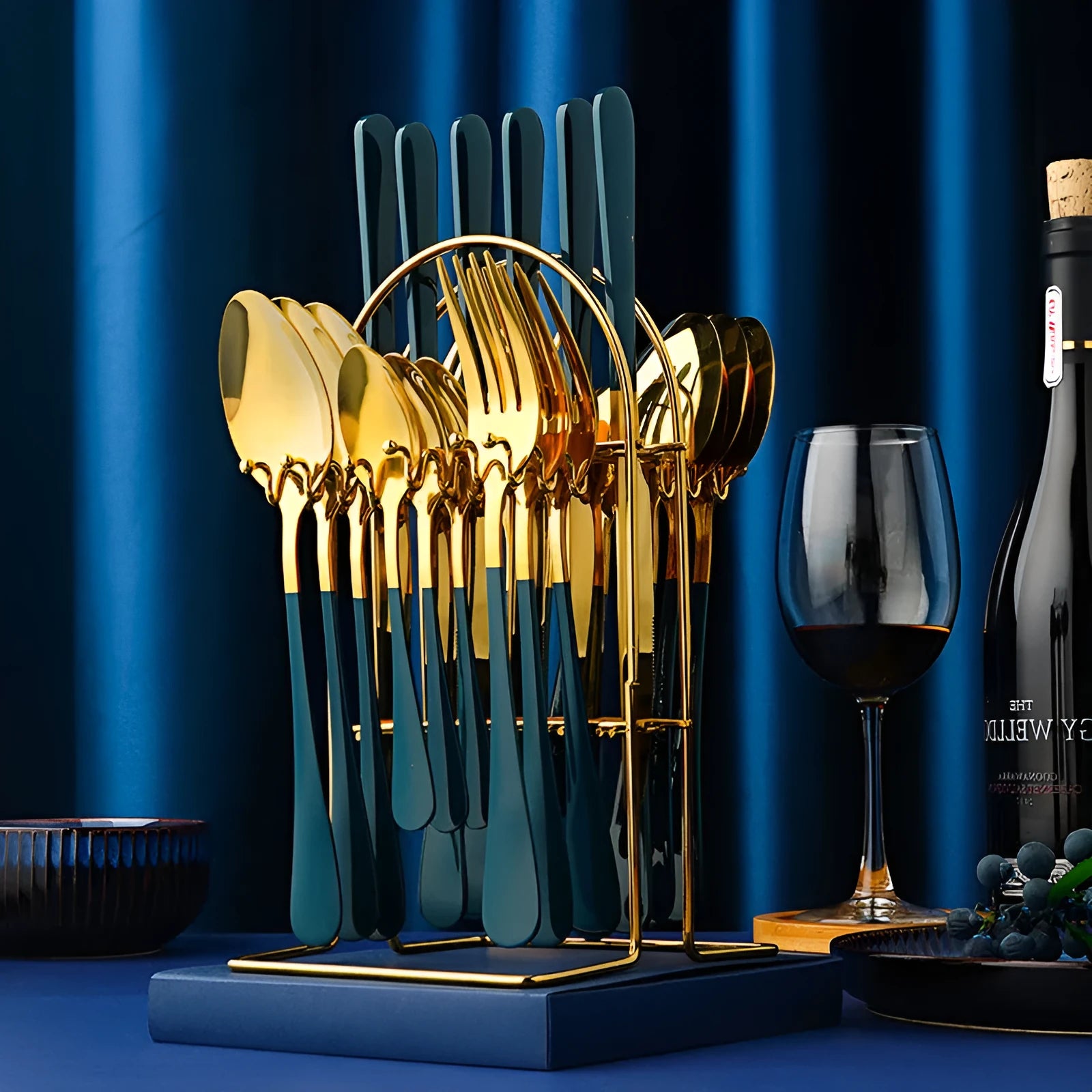 Gold stainless steel 24-piece cutlery set with storage rack containing knives, forks, spoons and teaspoons