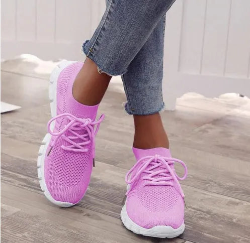 Women's breathable high-cut lace-up casual sneaker on a flat platform heel with a rubber sole.
