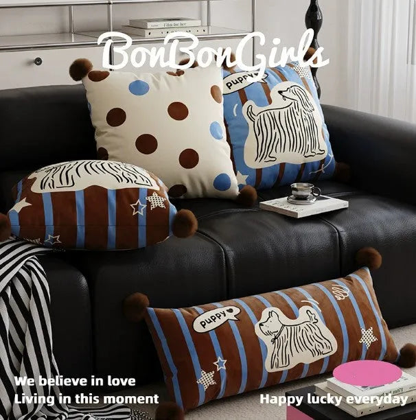 Cartoon printed cushion pillow with cute animal design on a sofa, showing blue colour and square shape.