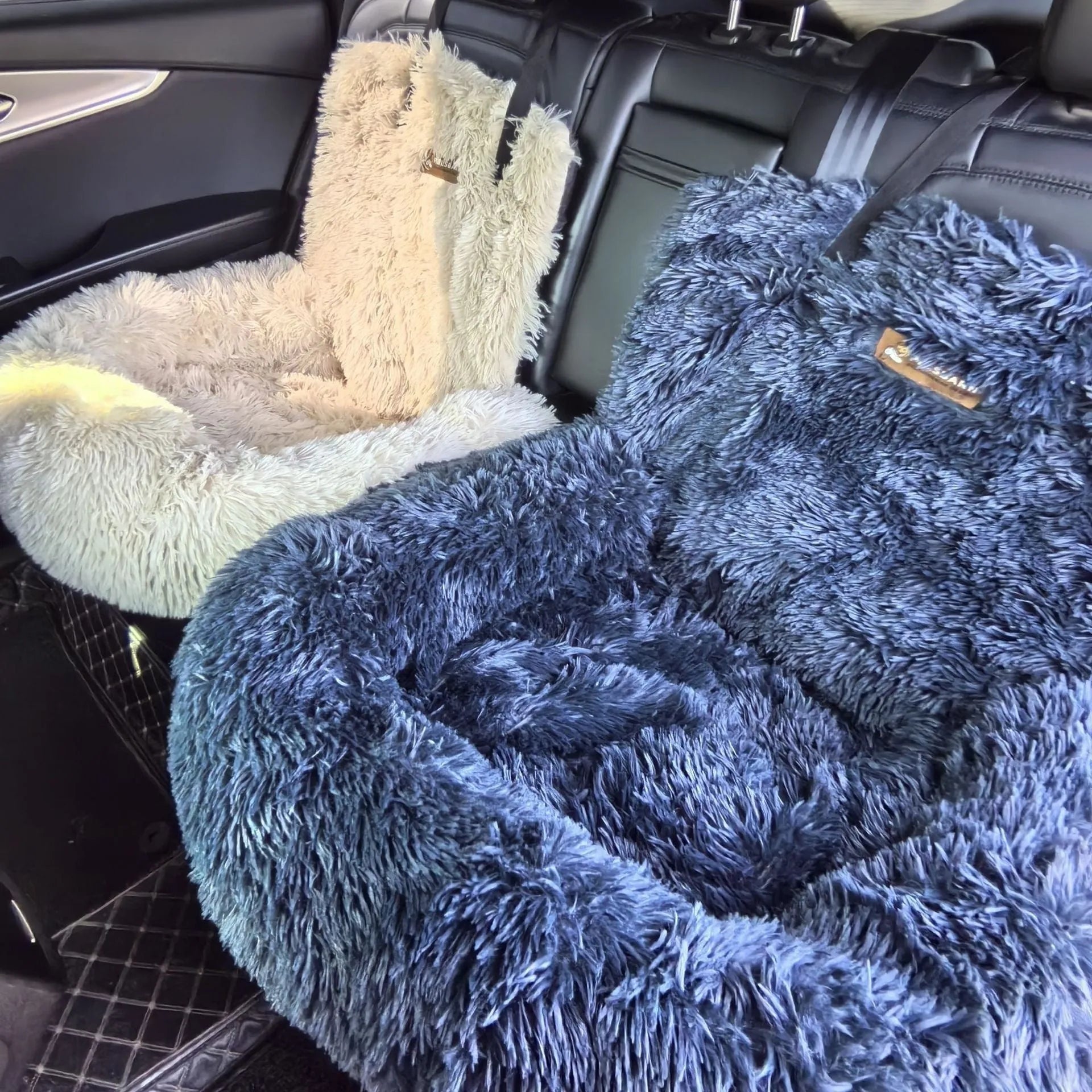 Dark grey thick thermal pet mat placed on a car seat.
