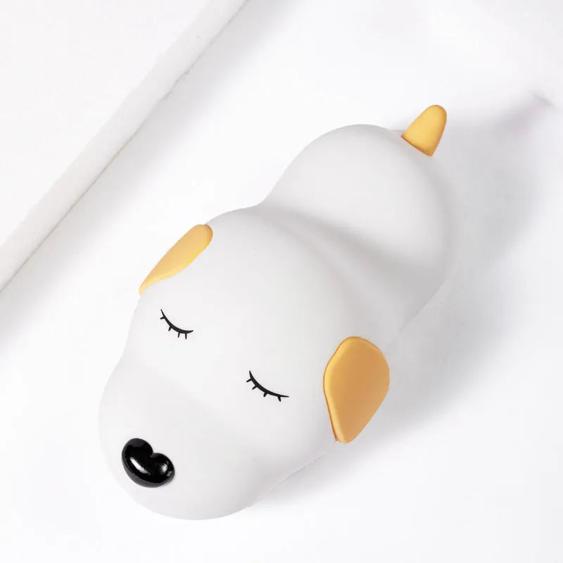 Cute two-tone cartoon dog silicone night lamp with USB cable for charging.