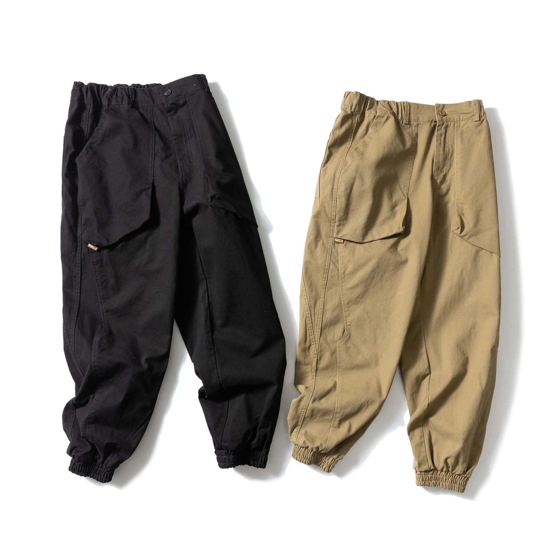 Black cotton tapered casual pants with ankle tie and large pocket.