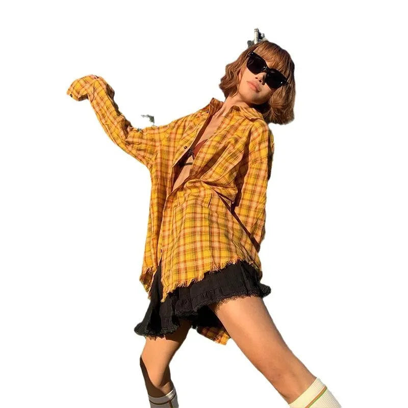 Yellow and black plaid shirt with a loose cardigan-style fit on a hanger.