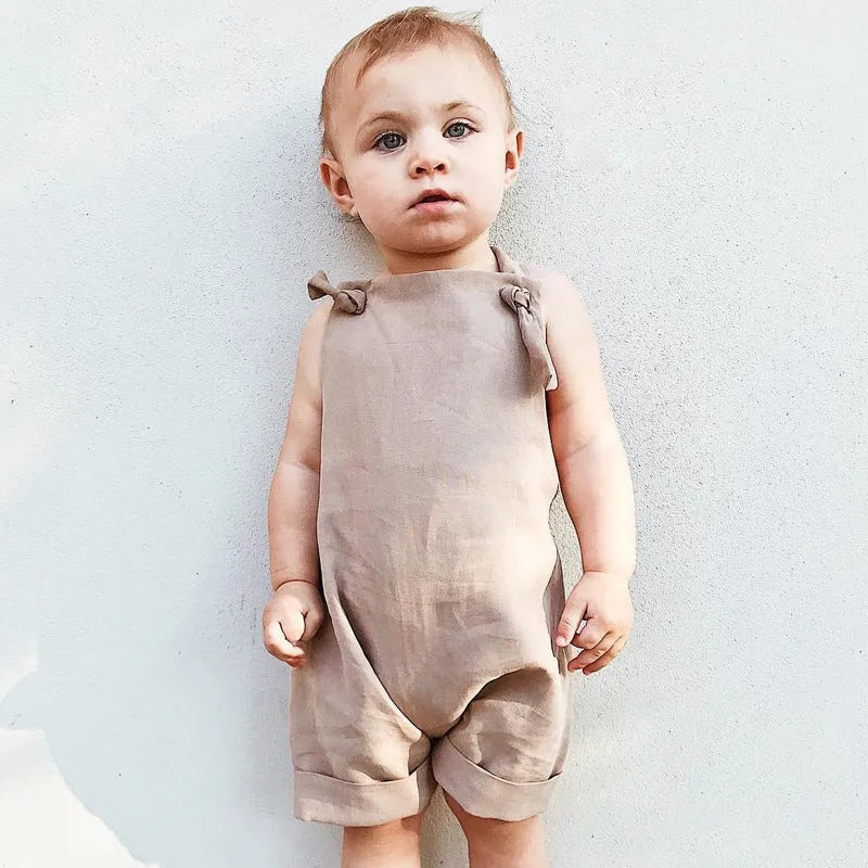 Children's khaki cotton overalls shorts with bow detail and straps, front view