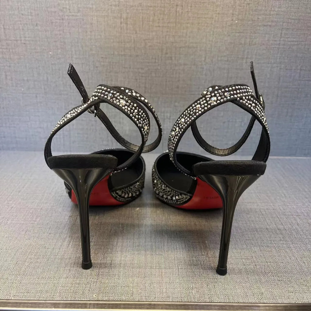 Women's black hollow high heel court shoe with red sole and pointed toe, stiletto heel.