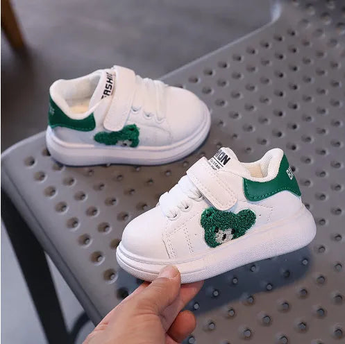 Children's black casual sports shoes with a cartoon bear design on the side, featuring an artificial leather upper and rubber sole.