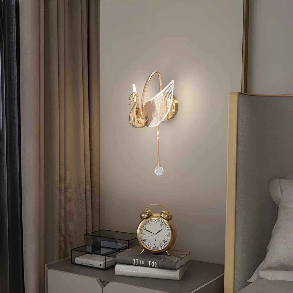Minimalist swan-shaped wall lamp with gold finish and white acrylic shade.