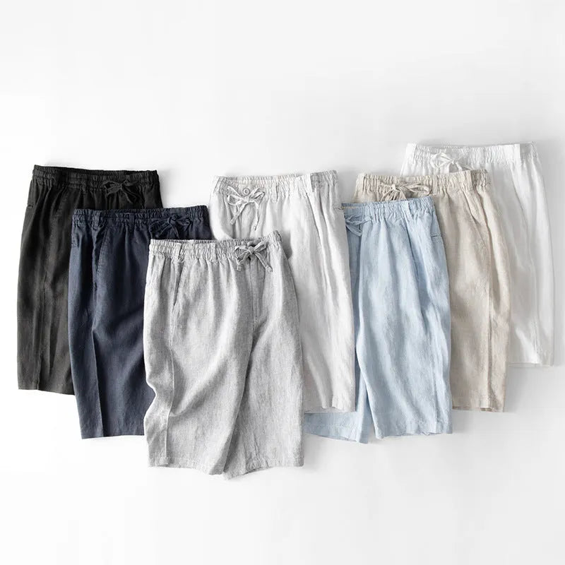 Men's loose-fit linen capri trousers in a straight leg style on a hanger.