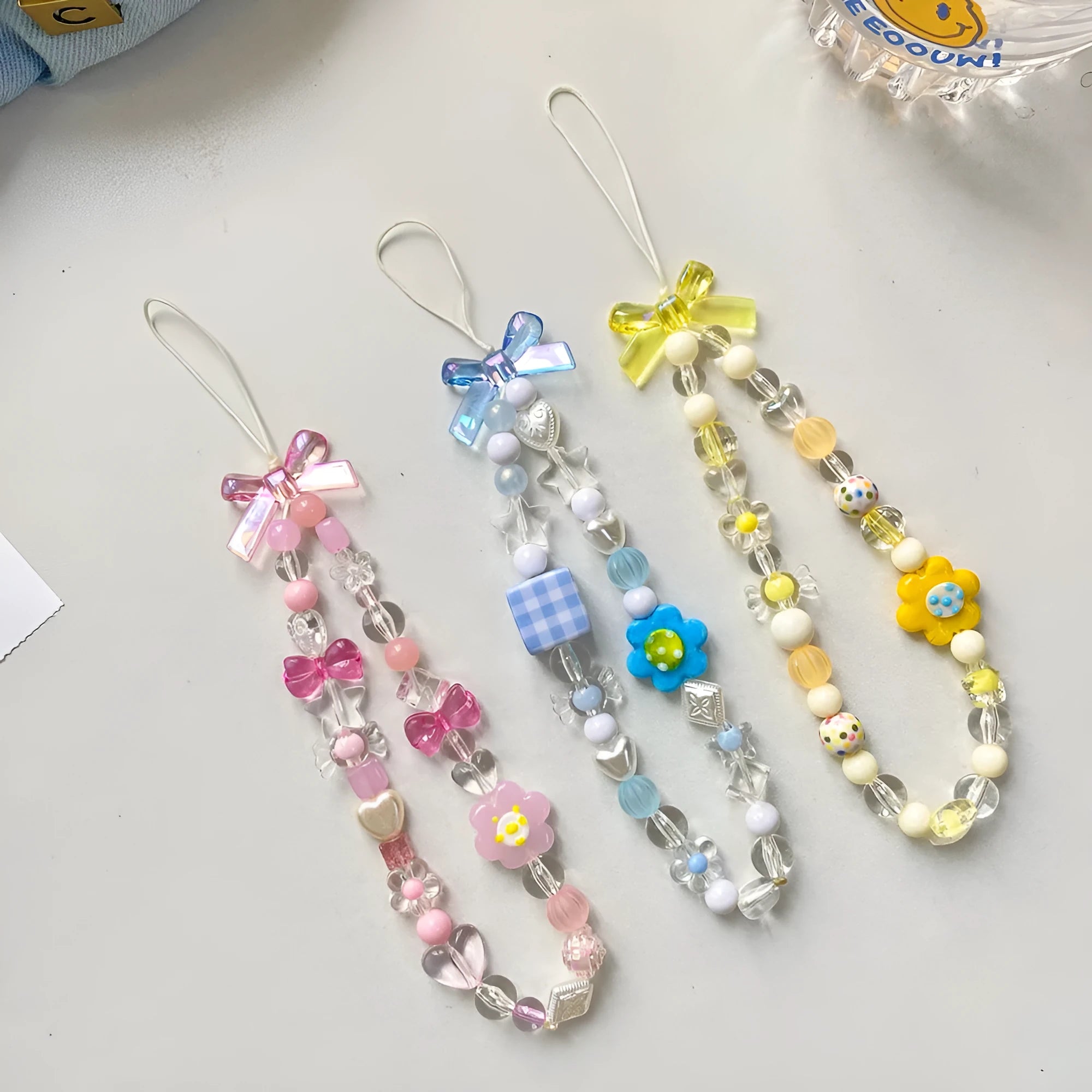 Beaded flower mobile phone lanyard in yellow, blue and pink colour options with plastic resin construction