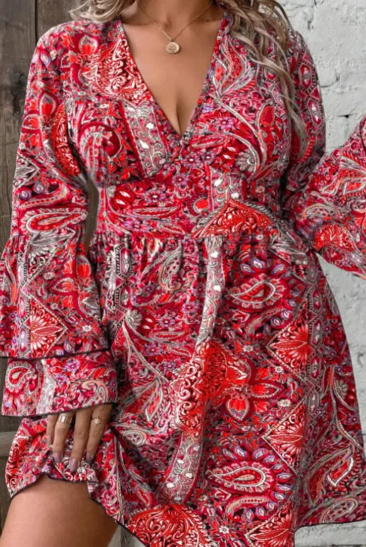 Women's plus size printed V-neck dress with bell sleeves and an A-line skirt in a bohemian style.