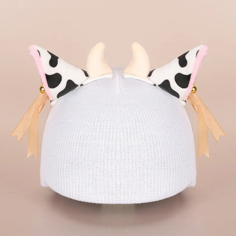 Plush cartoon-themed cover set on a medium motorcycle helmet with soft ear decorations.