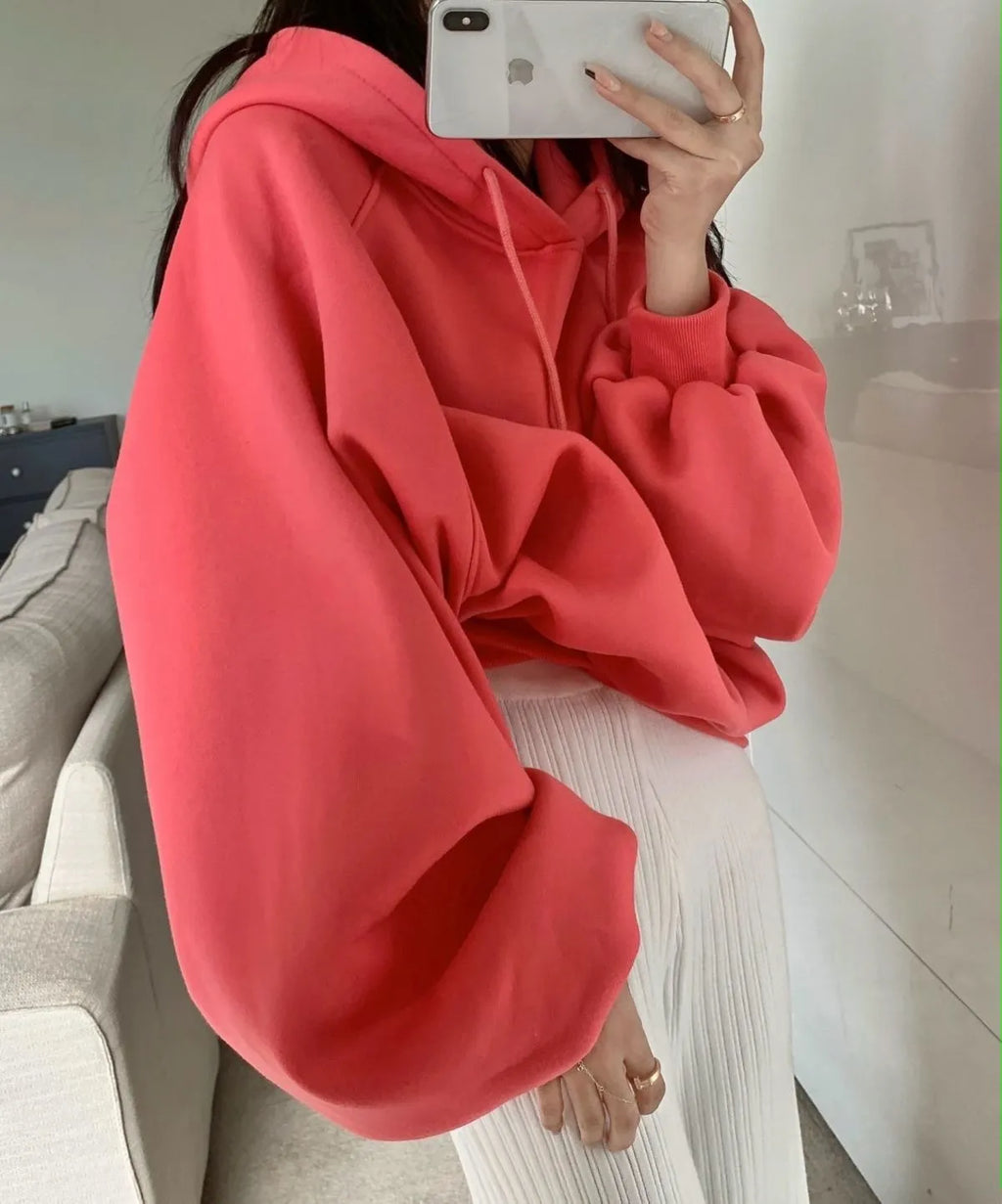 Watermelon red women's sleeveless hooded sweater made from mulberry silk on a hanger.
