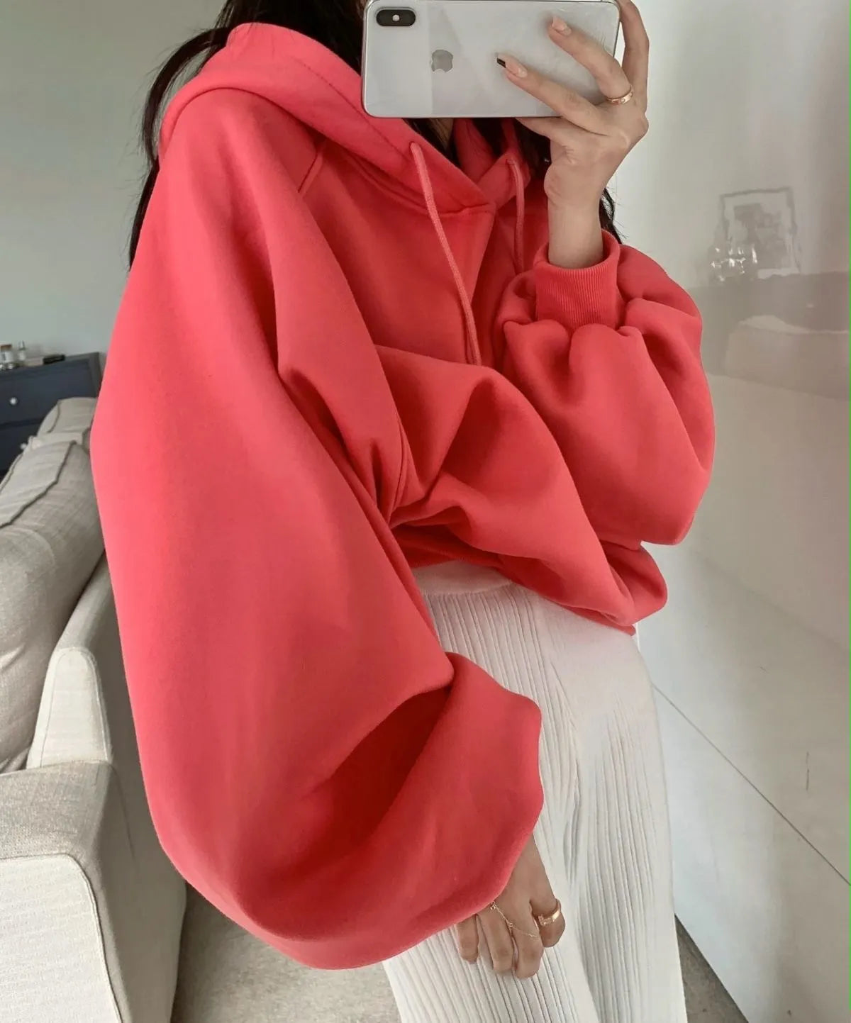 Watermelon red women's sleeveless hooded sweater made from mulberry silk on a hanger.