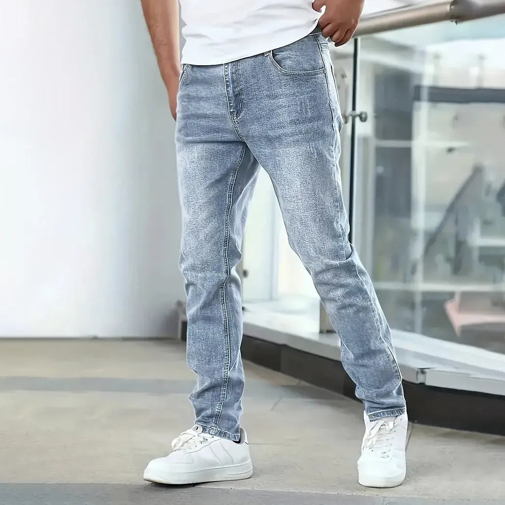 Men's straight-leg stretch jeans in black, dark blue, or grey, showing skinny leg opening and mid-waist fit.