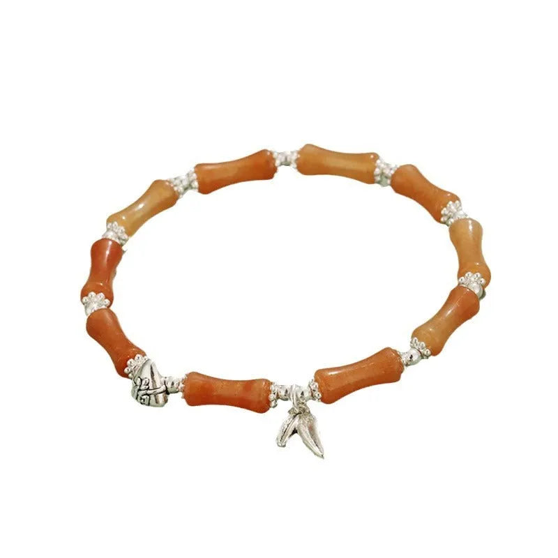 Green aventurine bamboo strawberry quartz crystal bracelet with mixed natural stones on wrist