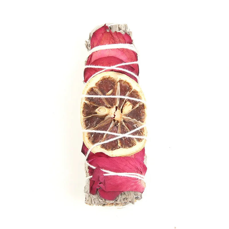 White sage and red rose petal colourful aromatherapy incense bundle on a wooden table