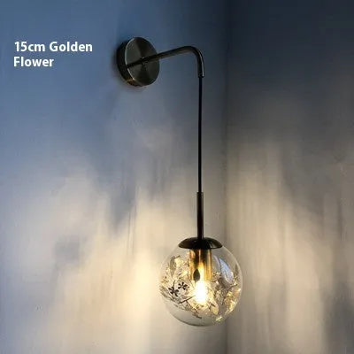 Modern glass wall lamp in golden flower or silver flower finish, shown in 15cm and 20cm sizes.