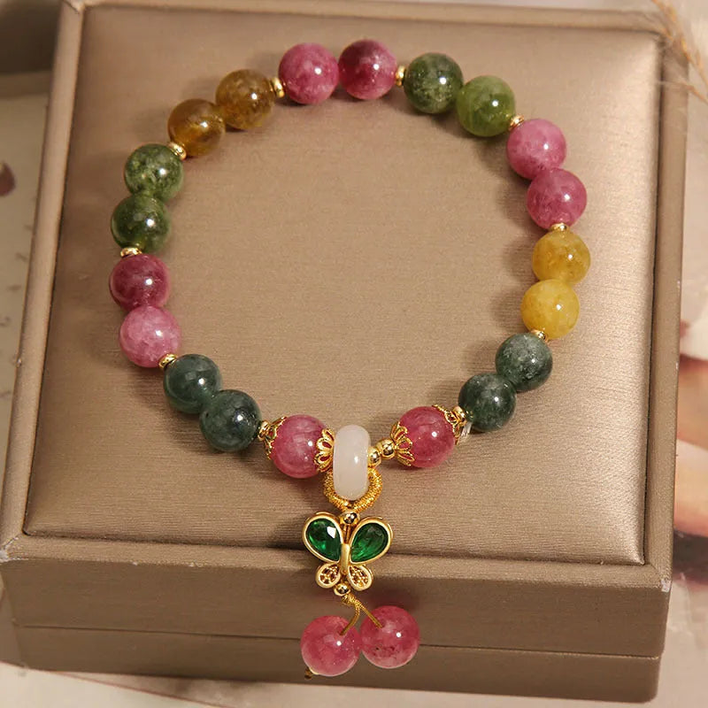 Women's bracelet with natural jade colour tourmaline butterfly pendant and rhinestone accents on alloy setting.