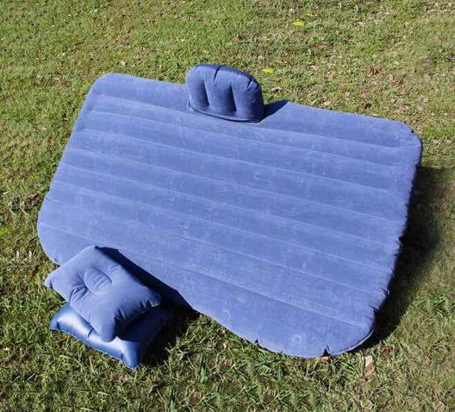 Inflatable car bed with flocked surface and two pillows, shown inside a five-seater vehicle.