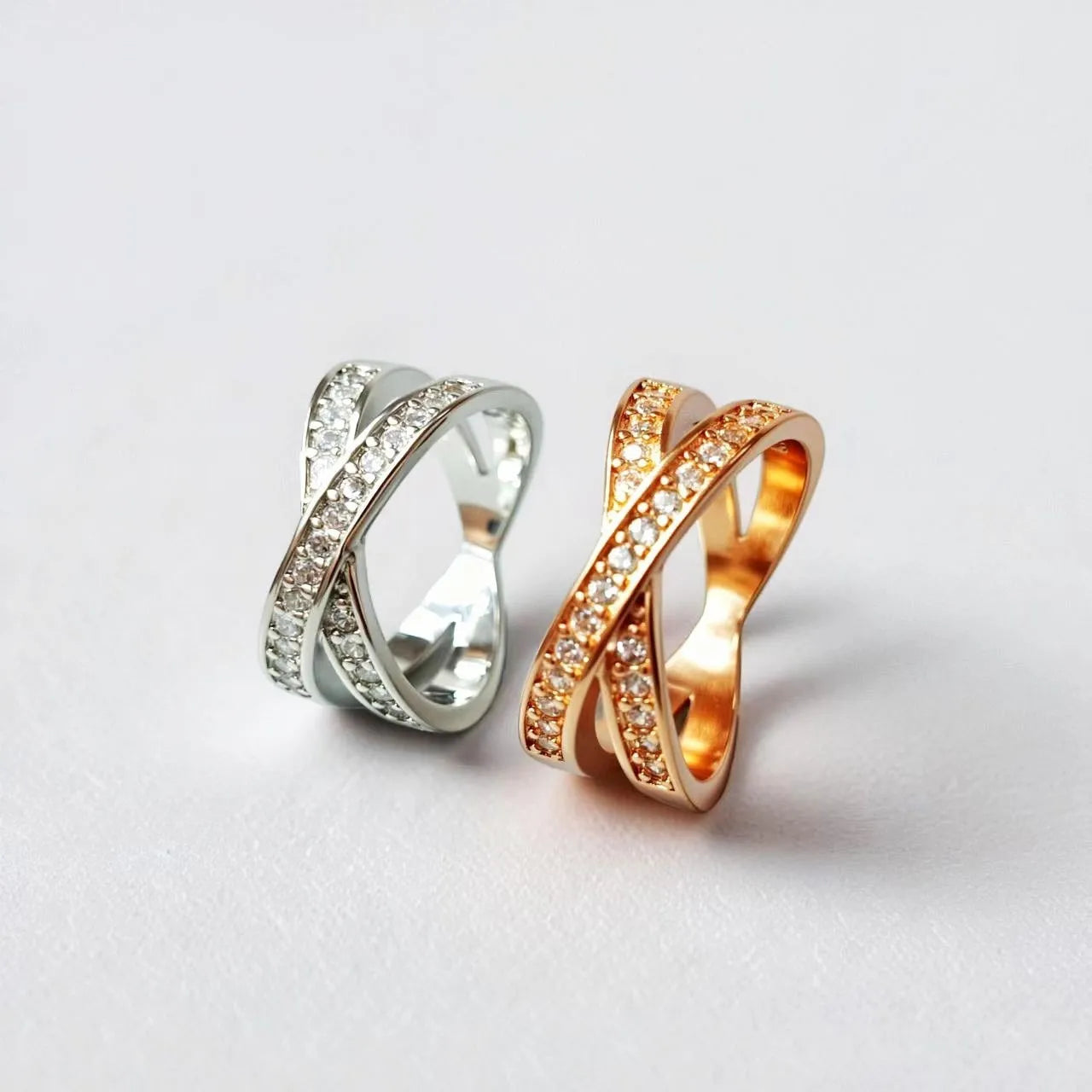 Geometric heart-shaped copper cross ring with micro-inlaid zircon in silver or rose gold finish.