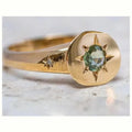 Gold coloured adjustable ring with a star shape and oval zircon stone