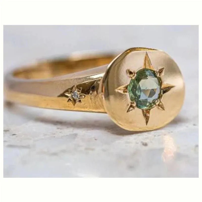 Gold coloured adjustable ring with a star shape and oval zircon stone