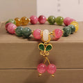 Women's bracelet with natural jade colour tourmaline butterfly pendant and rhinestone accents on alloy setting.