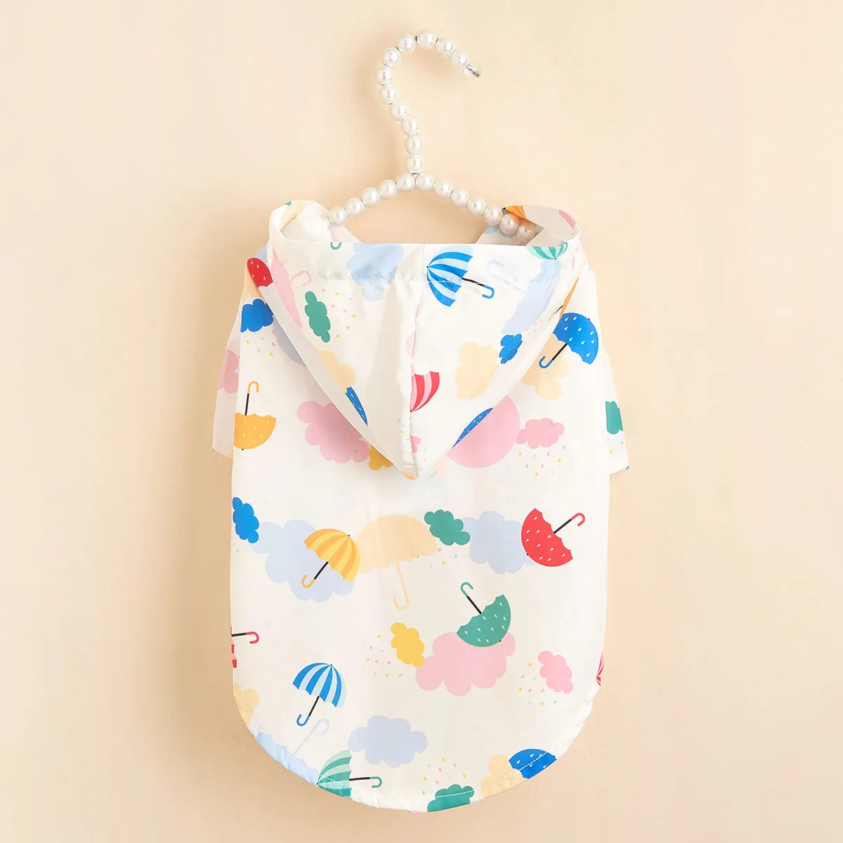 Colourful dog raincoat with a cartoon umbrella pattern, shown in size L on a mannequin.