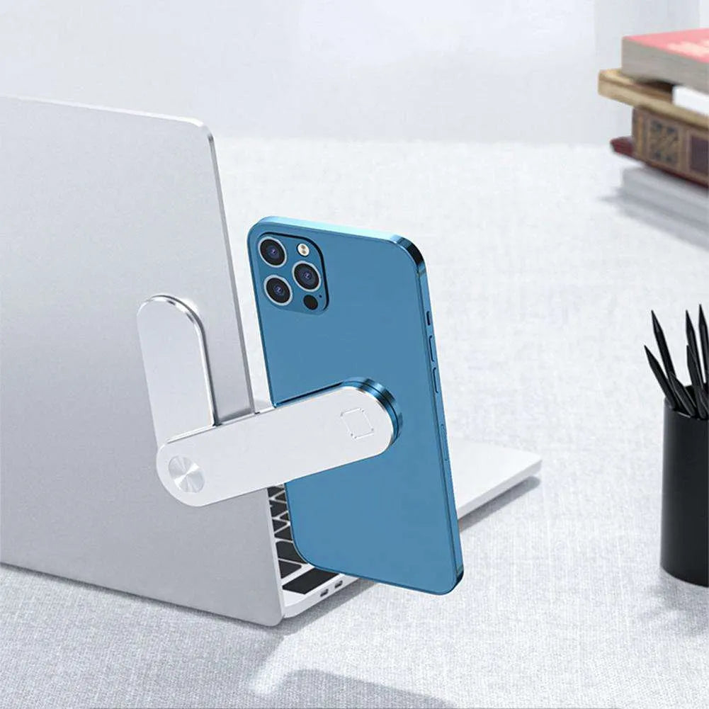 Black aluminium magnetic phone holder clipped to the side of a laptop screen with a smartphone attached.