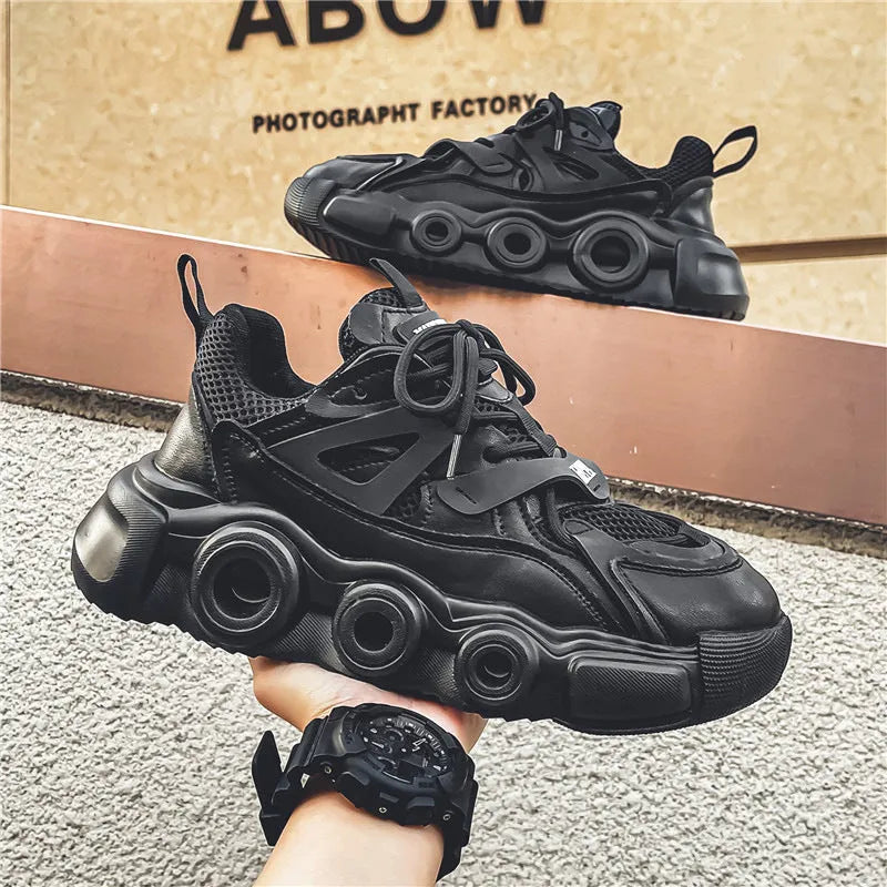Men's low-top casual sneaker in black with mesh upper, thick rubber sole, and lace-up front.