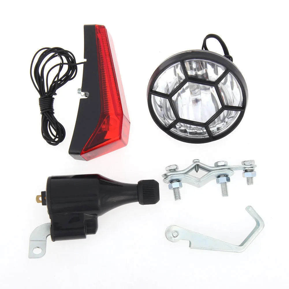 Silver bicycle dynamo-powered generator light kit mounted on a bicycle frame for front and rear lighting.