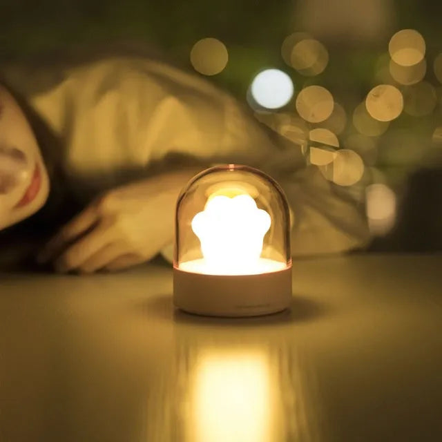 Grey and pink cat paw shaped night light with USB charging port and music box functions