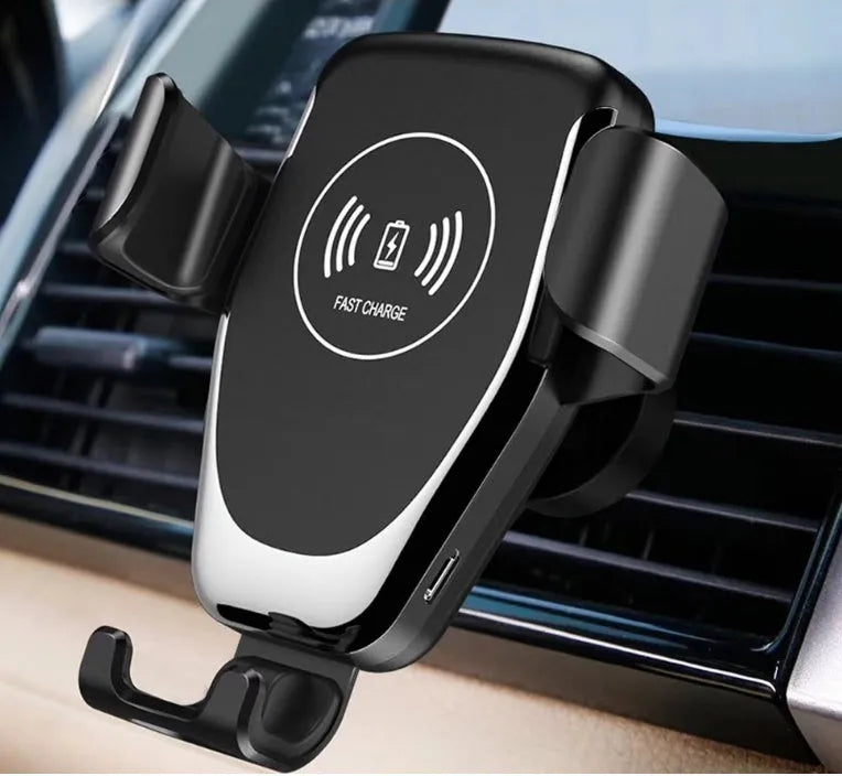 Black car wireless phone charger mounted on air vent, holding an iPhone with automatic clamping arms.