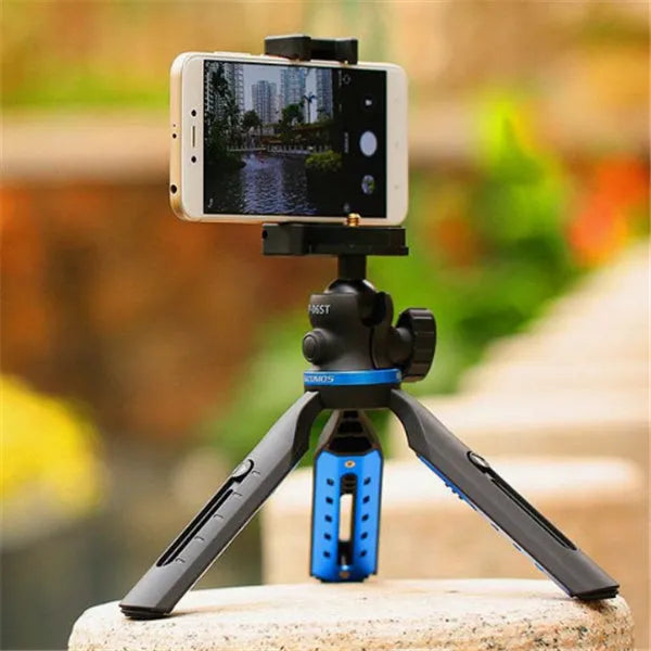 Black aluminium alloy and plastic desktop tripod stand holding a mobile phone.
