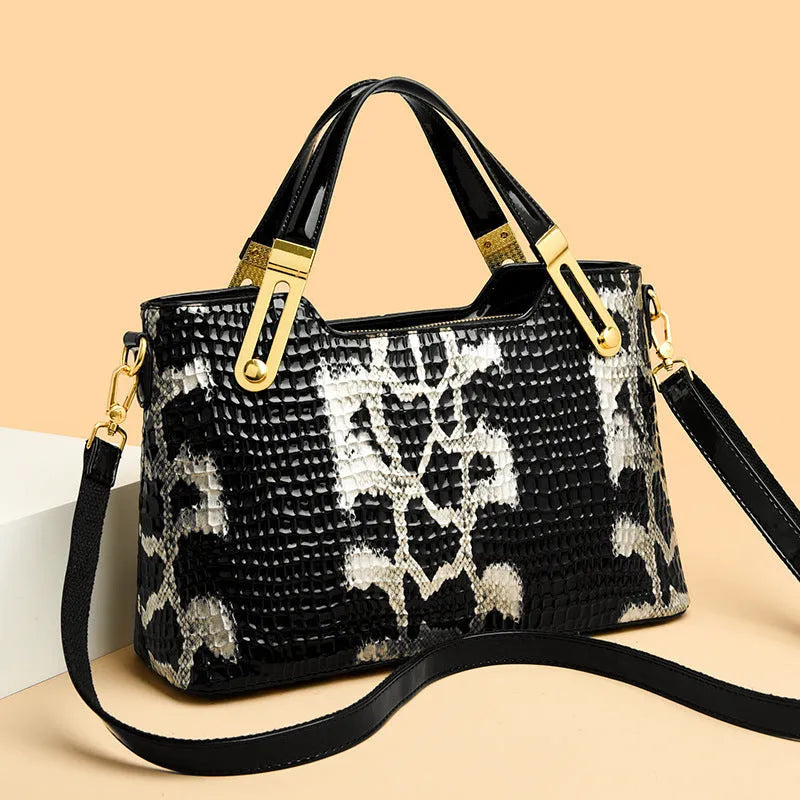 Retro black and white messenger bags with chain detail, showing internal phone and file compartments.
